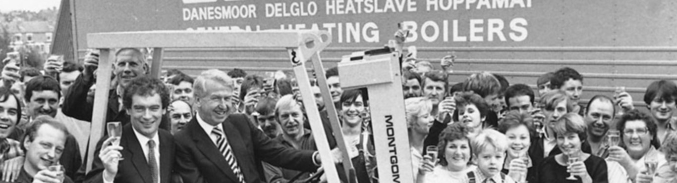 Black and white photo of a crowd drinking champagne.